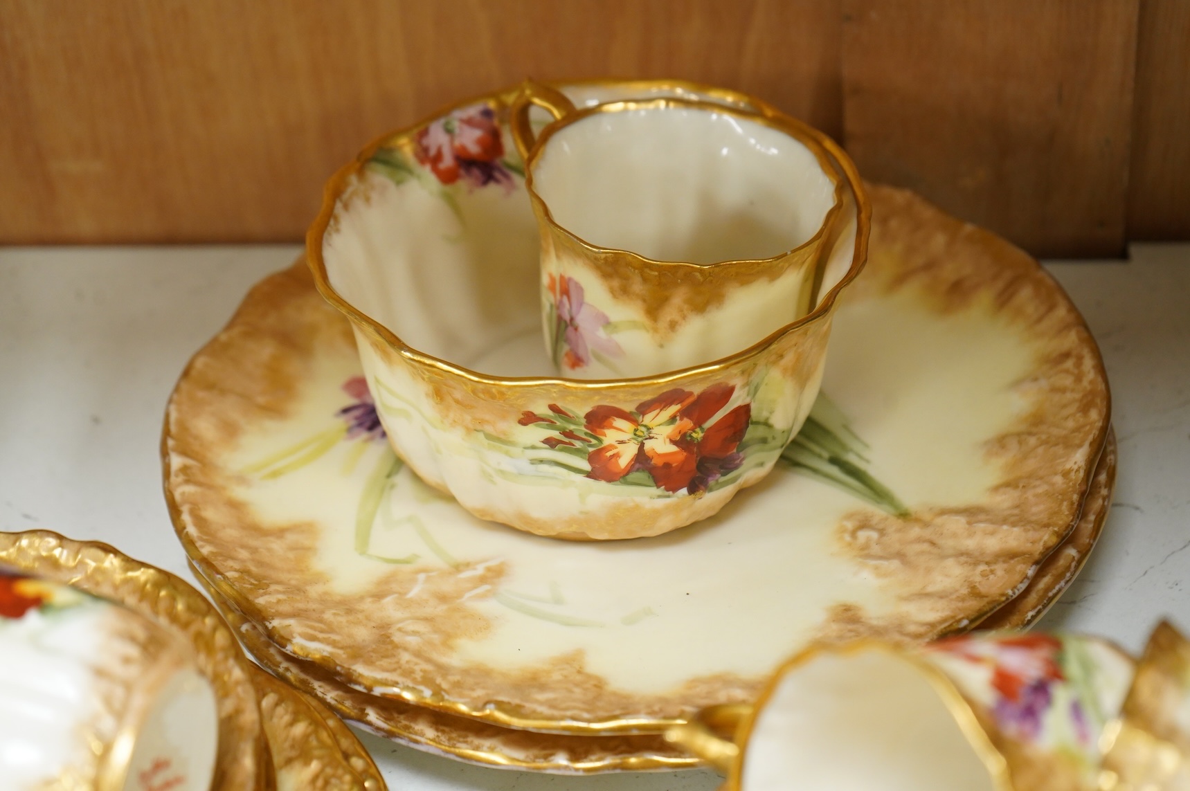 A ‘Nautilus’ porcelain floral and gilt decorated tea service, sandwich plates 23cm diameter.
